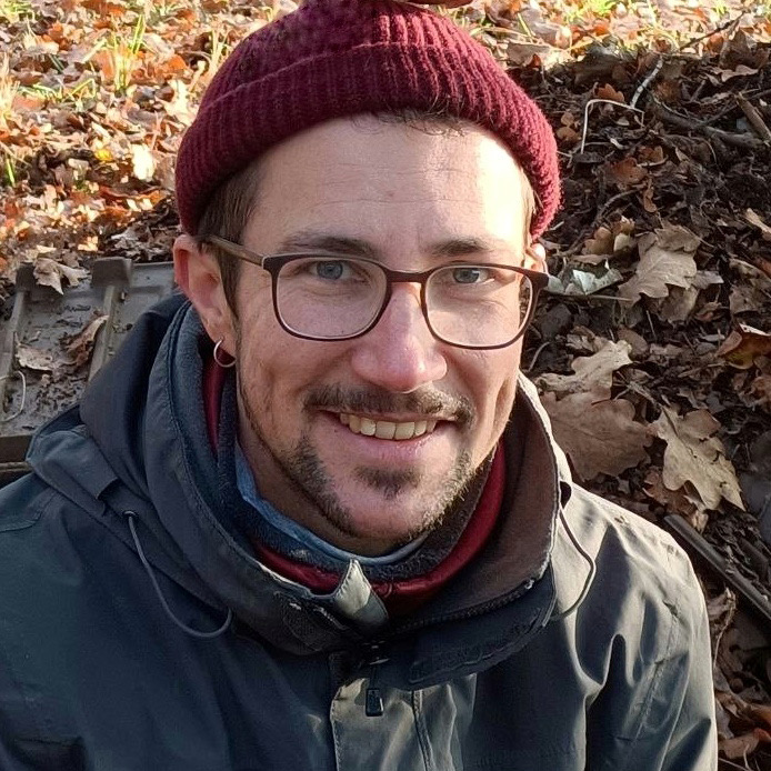 Person wearing glasses with a beanie