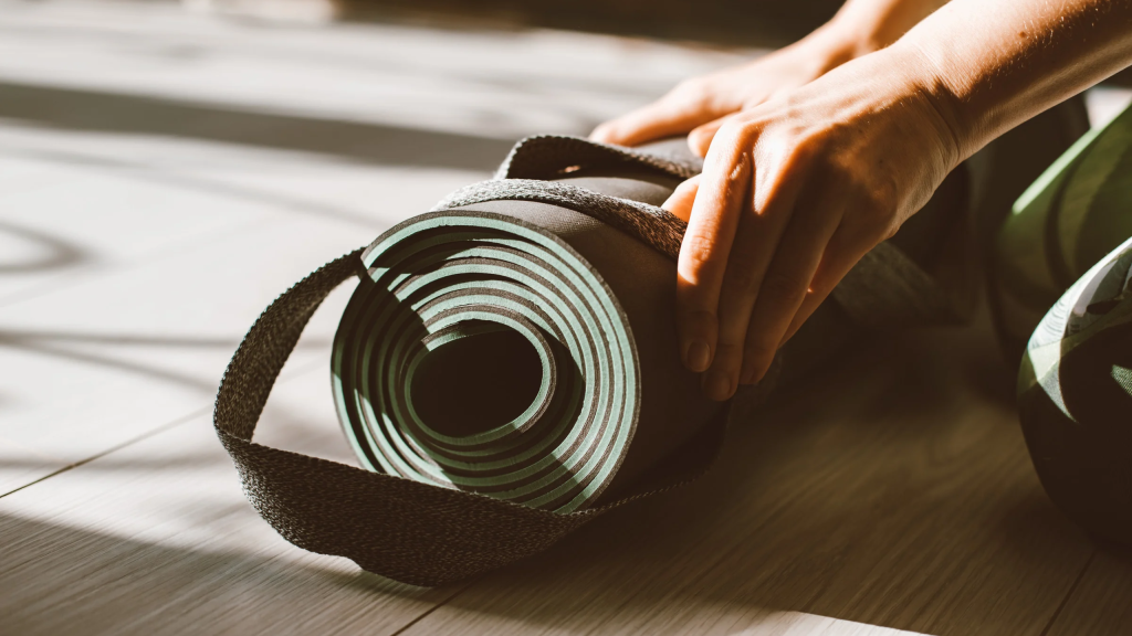Hands rolling a mat